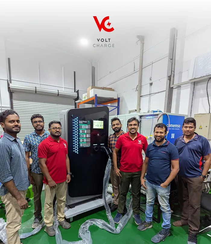 VOLT Charge team with a DC fast charger at the factory